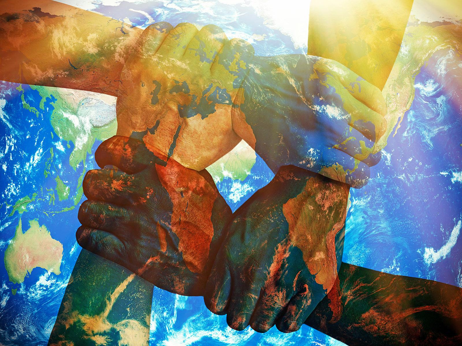 An illustration showing hands representing multiple human races united over the earth.
