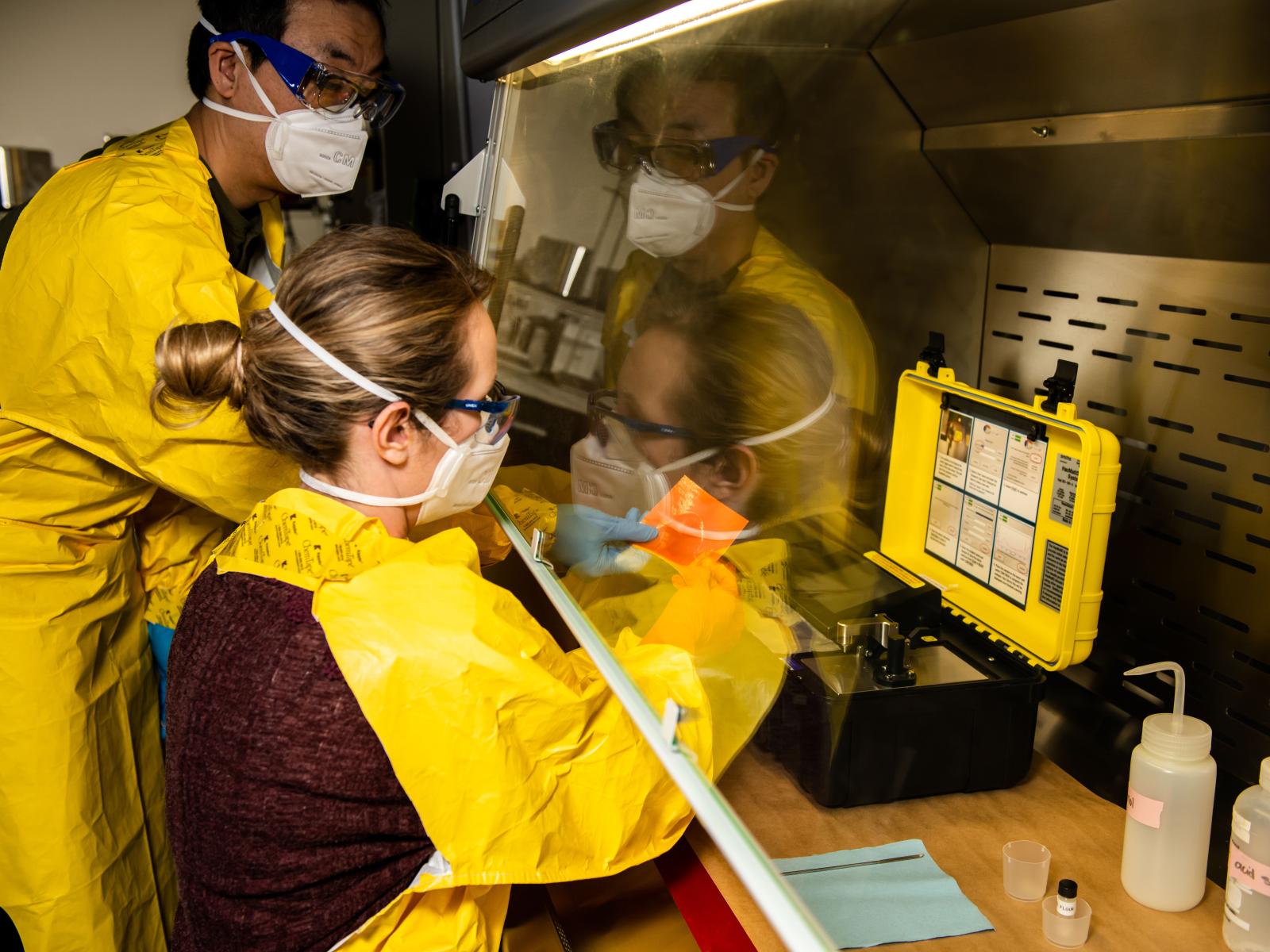 Researchers prepare fentanyl samples in a specialized hood to measure the substance’s spectra