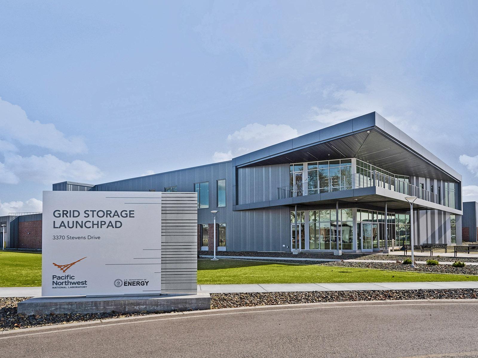 The exterior of the GSL building, with the building sign in the foreground