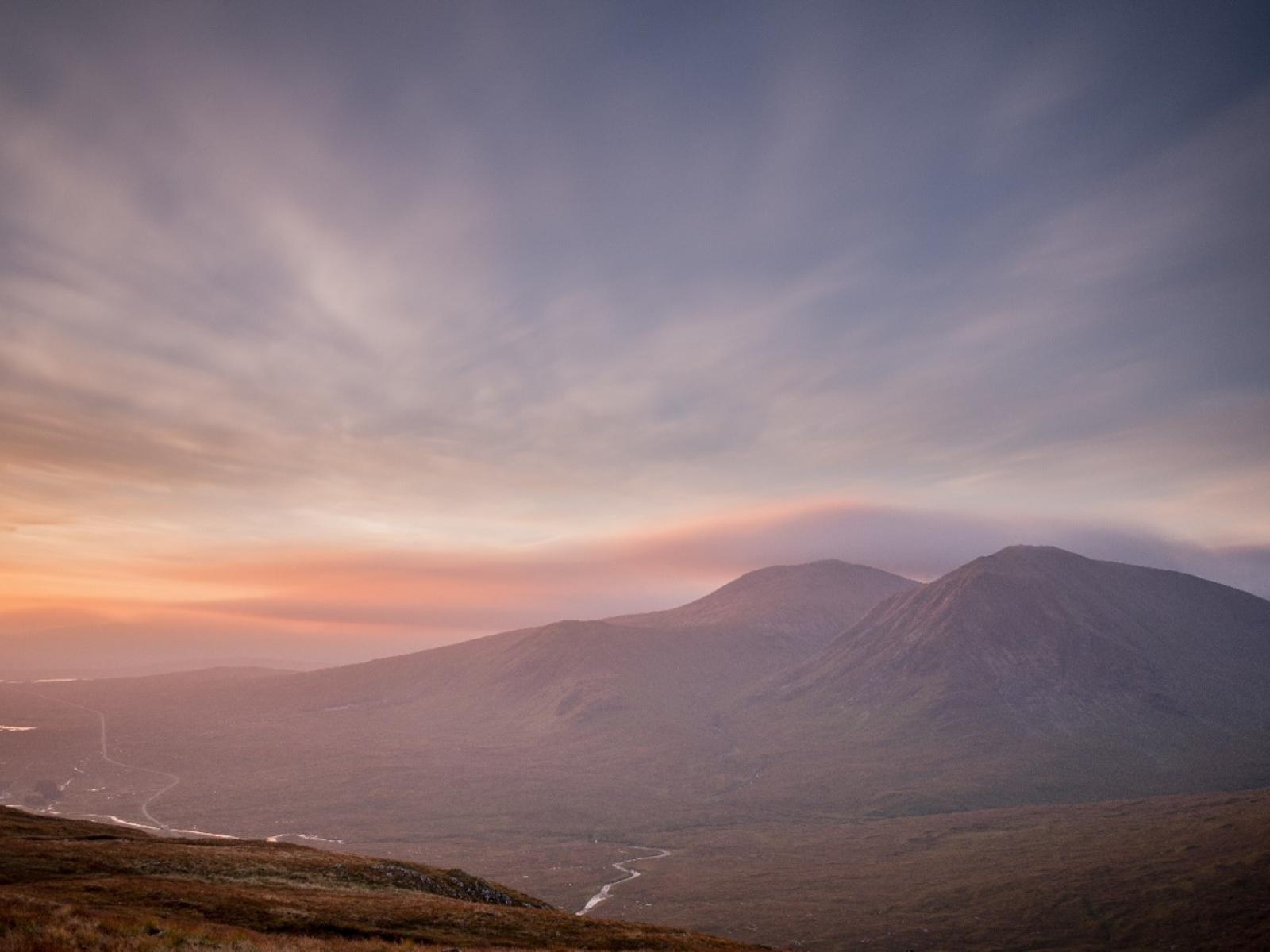 Photograph of a hazy sky over a striking landscape.