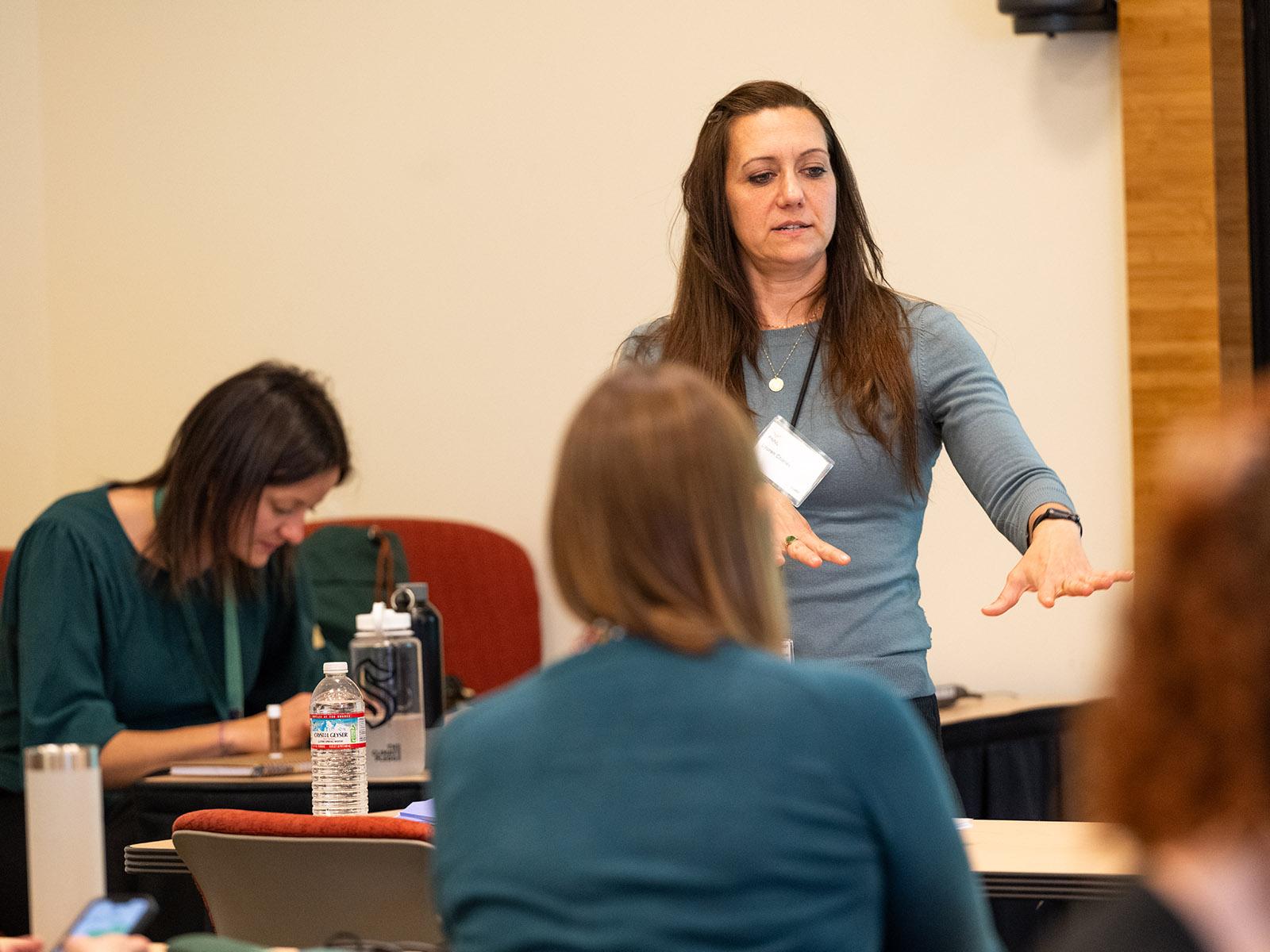A presenter giving a presentation in a room.