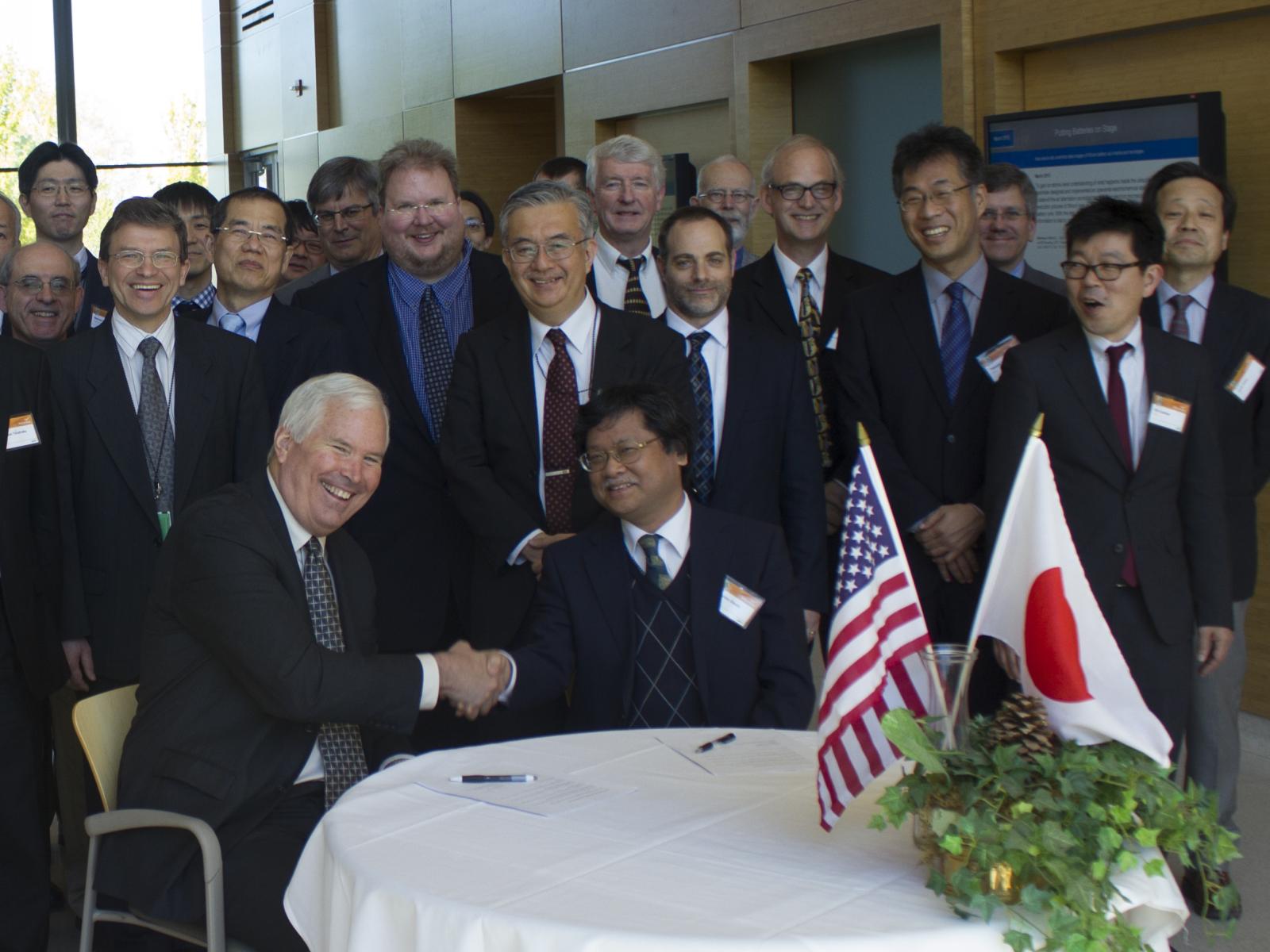 Picture of DOE's James Siegrist (left), associate director of the Office of Science for High Energy Physics, and Dr. Yasuhiro Okada, executive director, High Energy Accelerator Research Organization (KEK), Japan shaking hands.