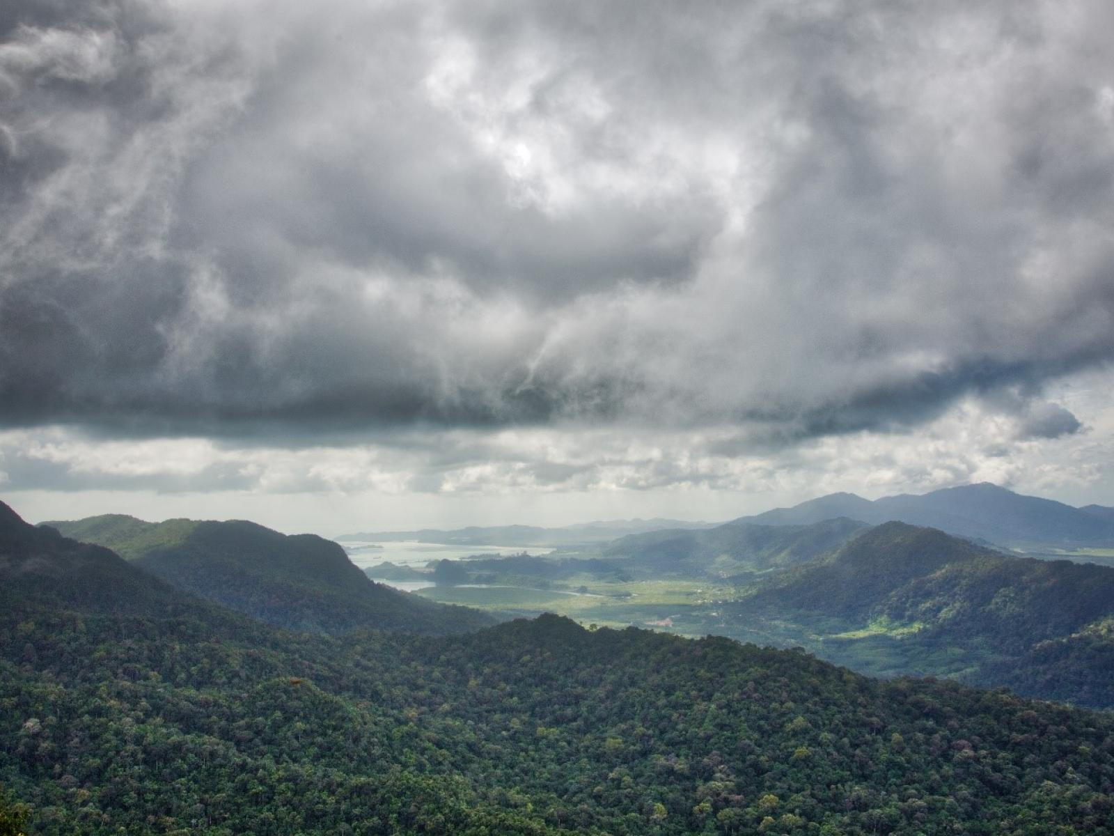 Photograph of tropical land with moody clouds