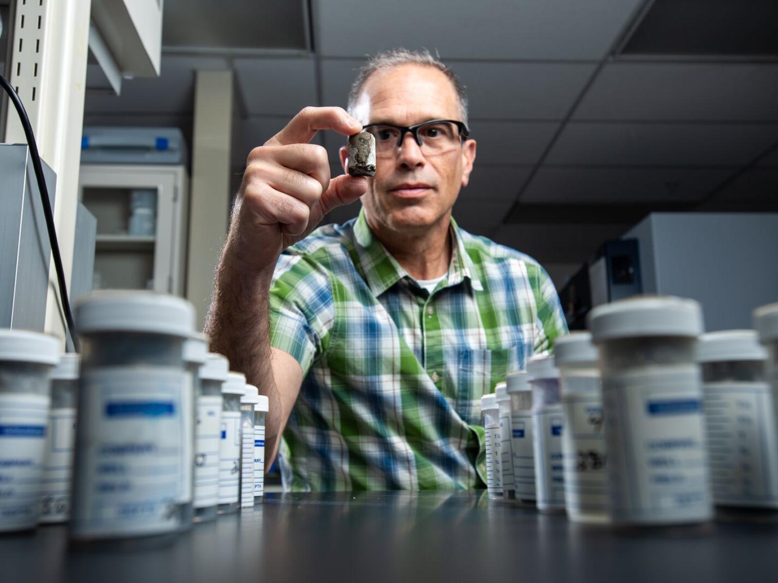 PNNL researcher holds a basalt sidewall core