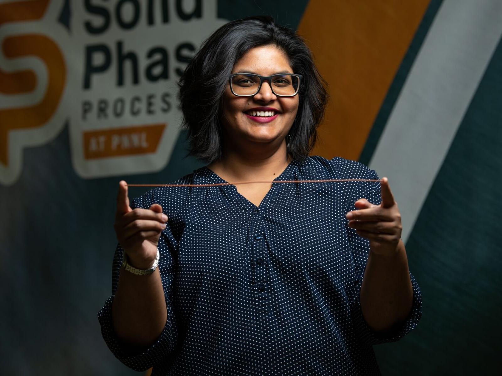 woman holding copper wire