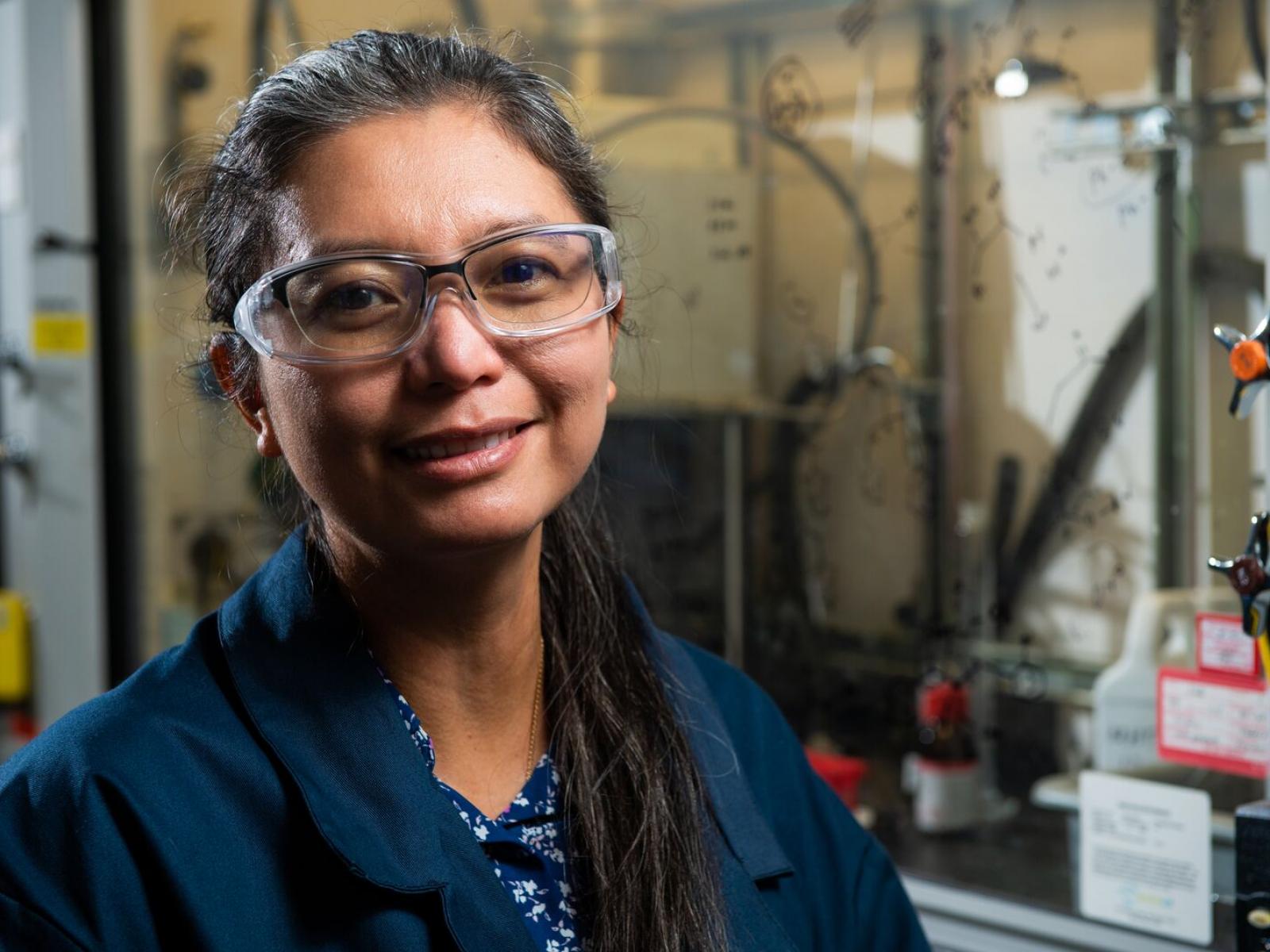Woman wearing safety glasses smiling