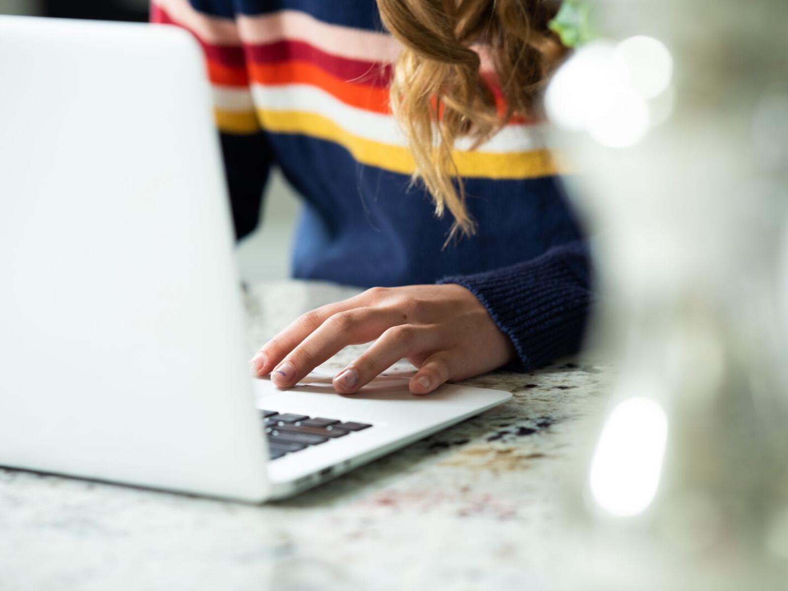 Close up of hands on a laptop computer