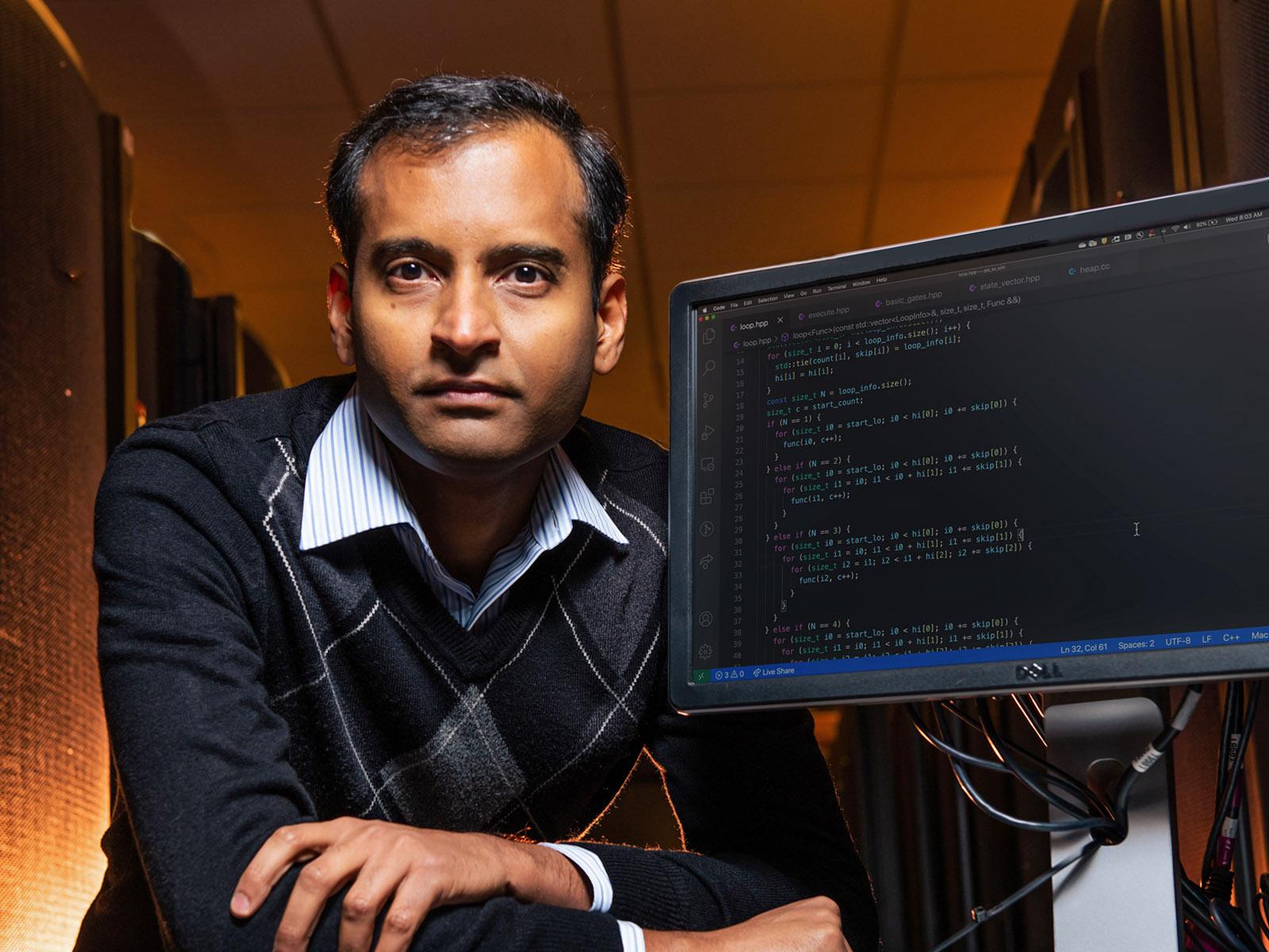 Sriram Krishnamoorthy poses with PNNL supercomputer