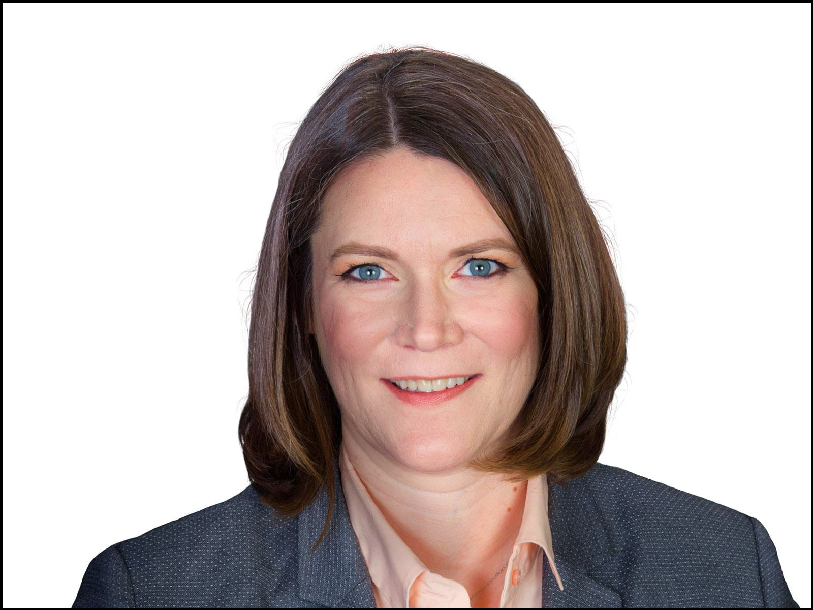 Woman with brown hair and gray jacket