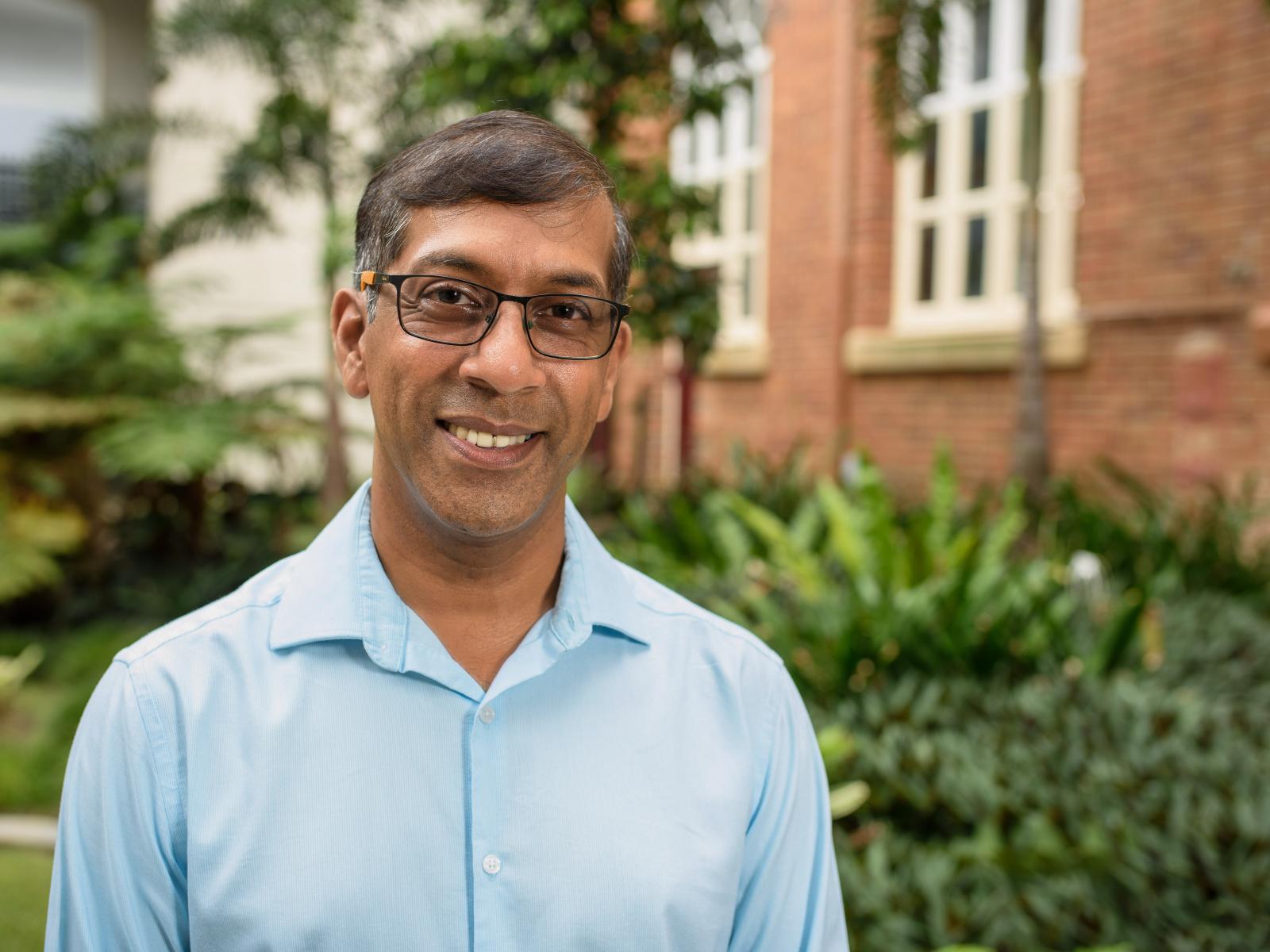 man wearing glasses smiles