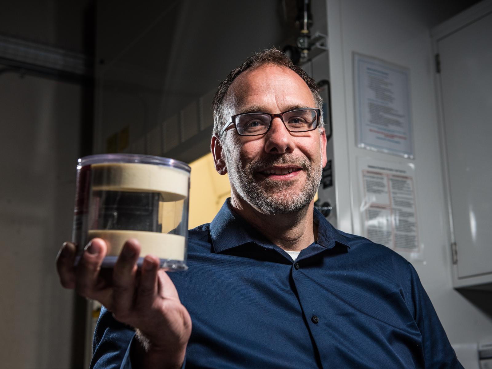 Nuclear forensics scientist Jon Schwantes holds up the uranium cube believed to be a Heisenberg Cube.