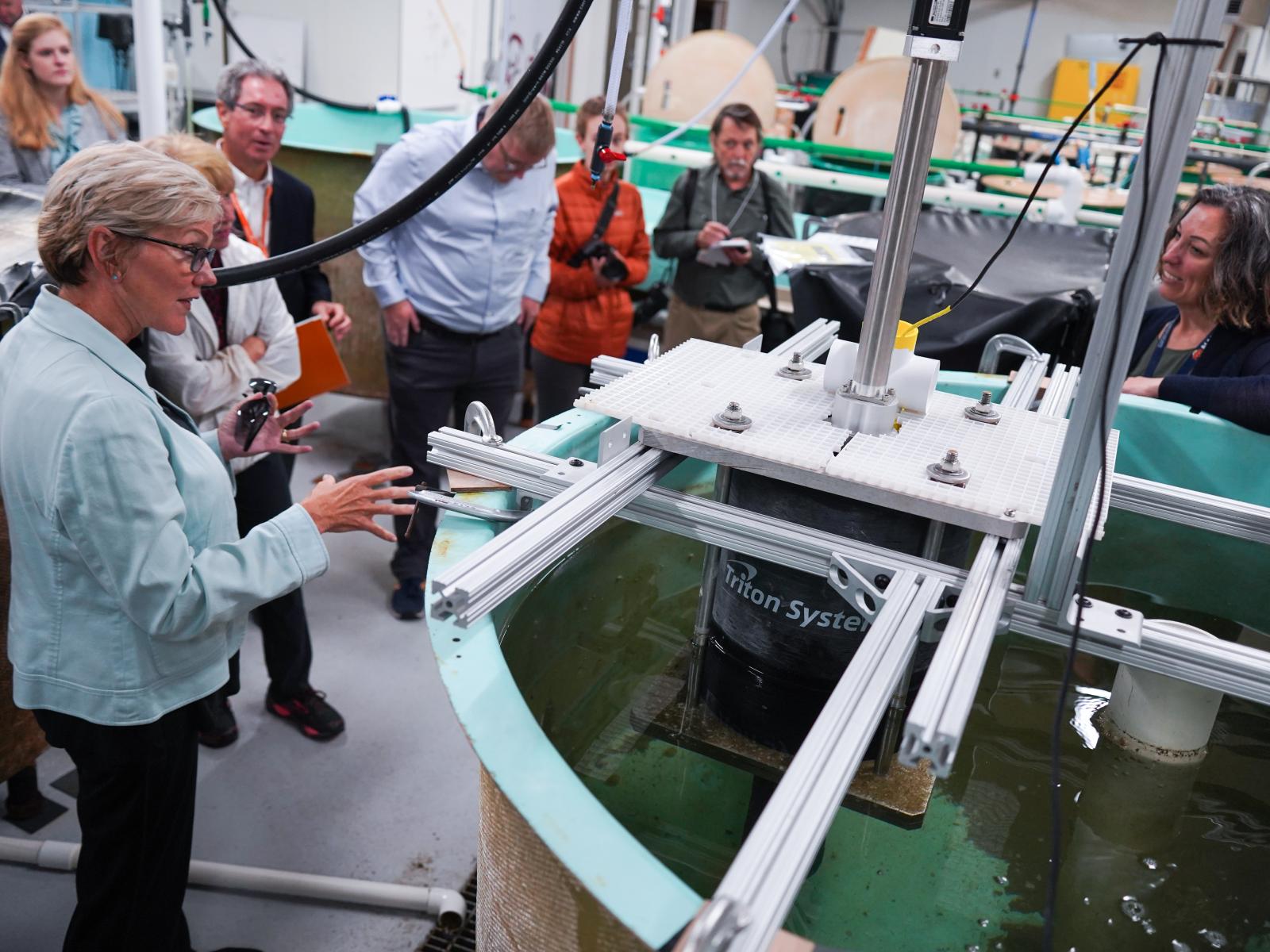 PNNL scientists explain ongoing marine research in laboratory tanks to Secretary Granholm.