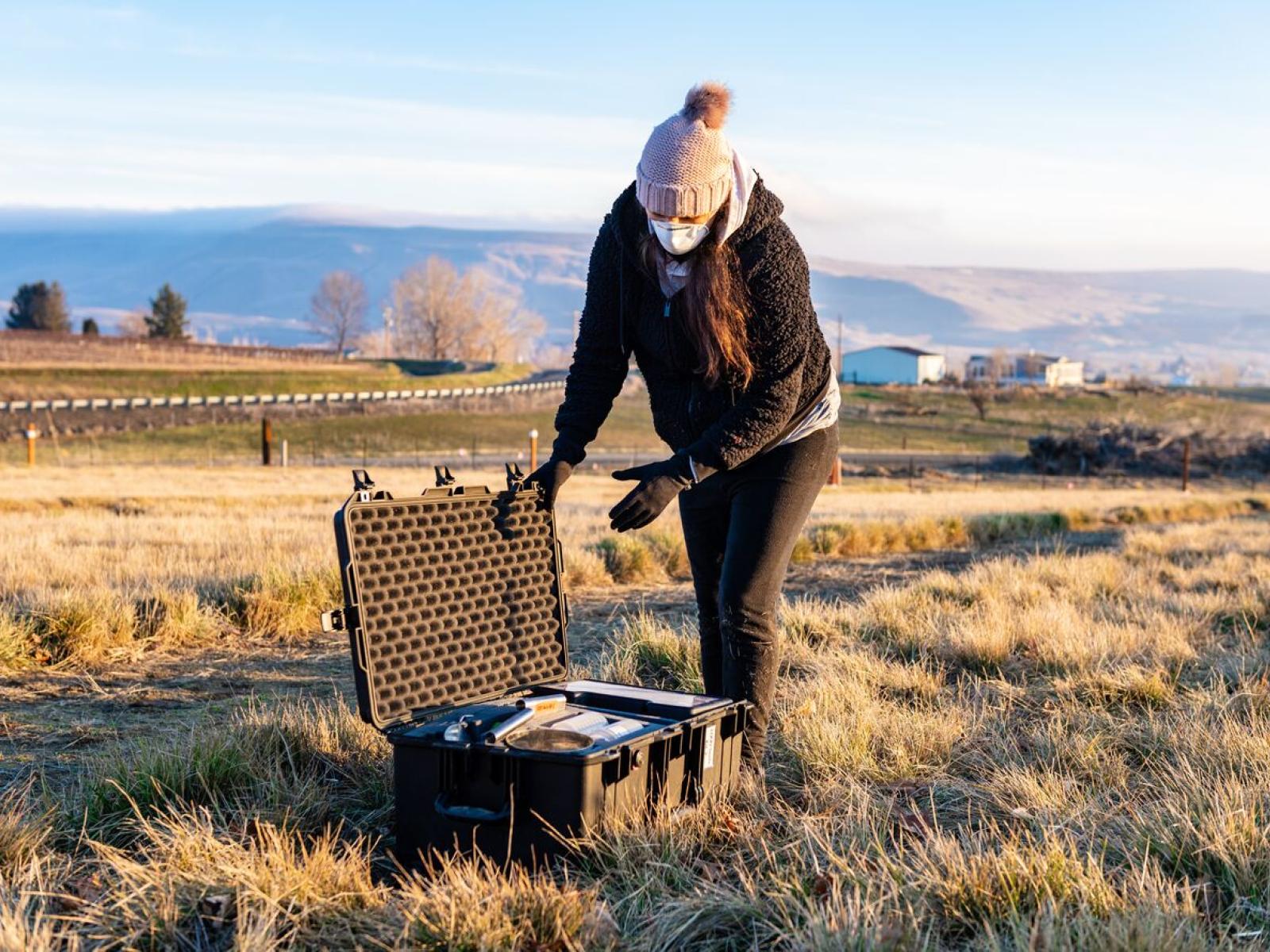 Emily Graham collecting soil as part of her work studying microbes in the soil.