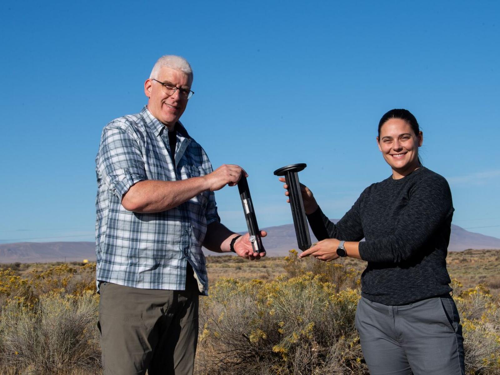 Kenton Rod and Regan McDearis hold custom stakes for soil research