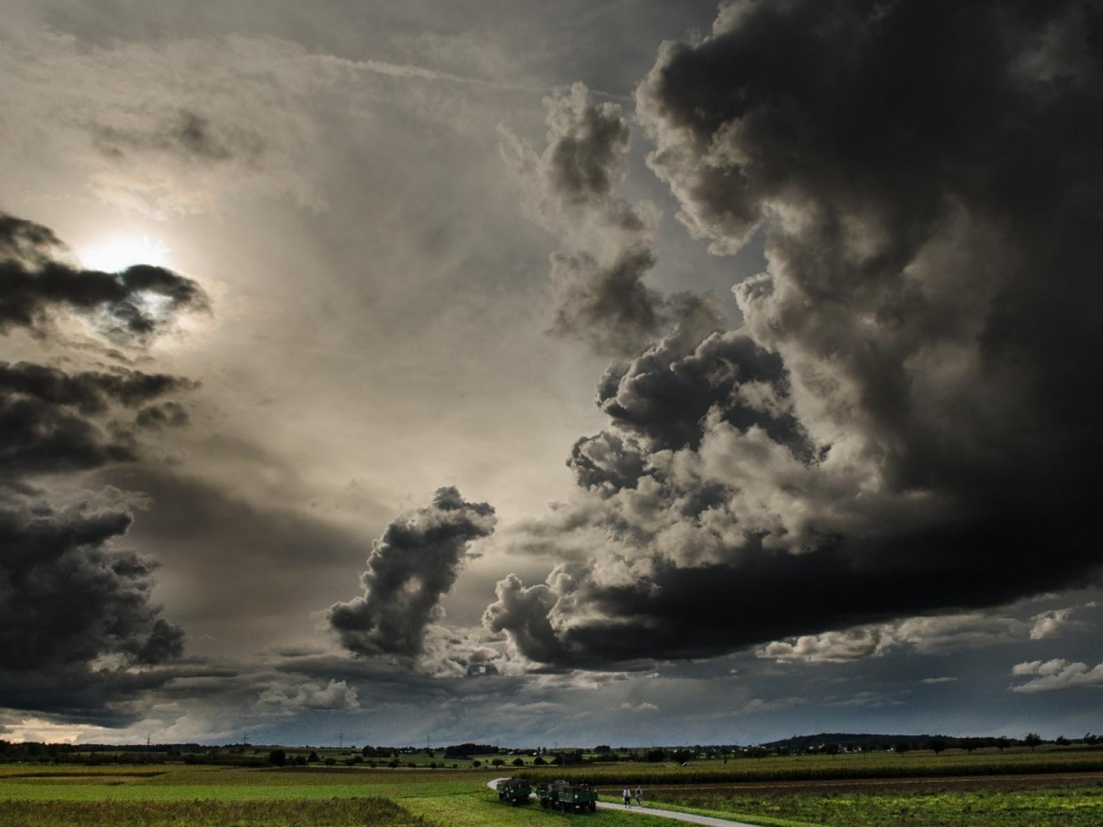 Dark stormy clouds over green agricultural land