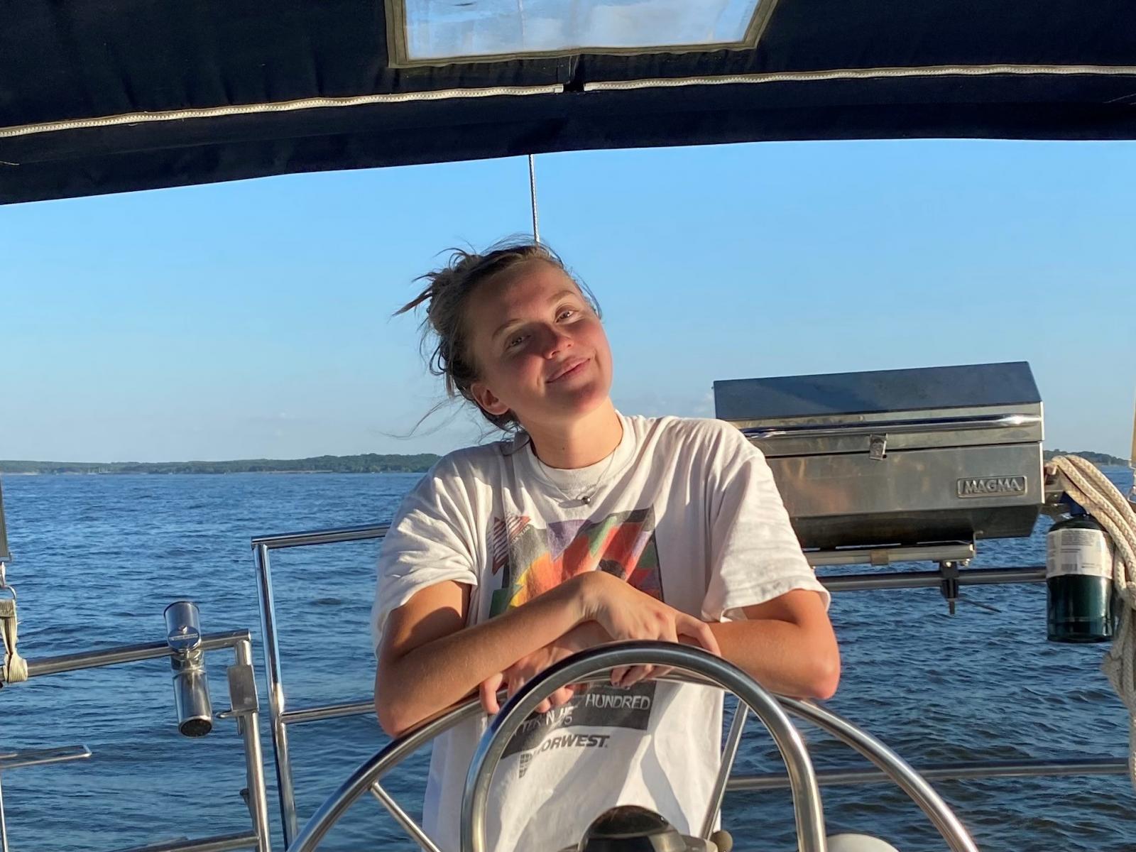 Christa Hvidsten smiling from a boat. 
