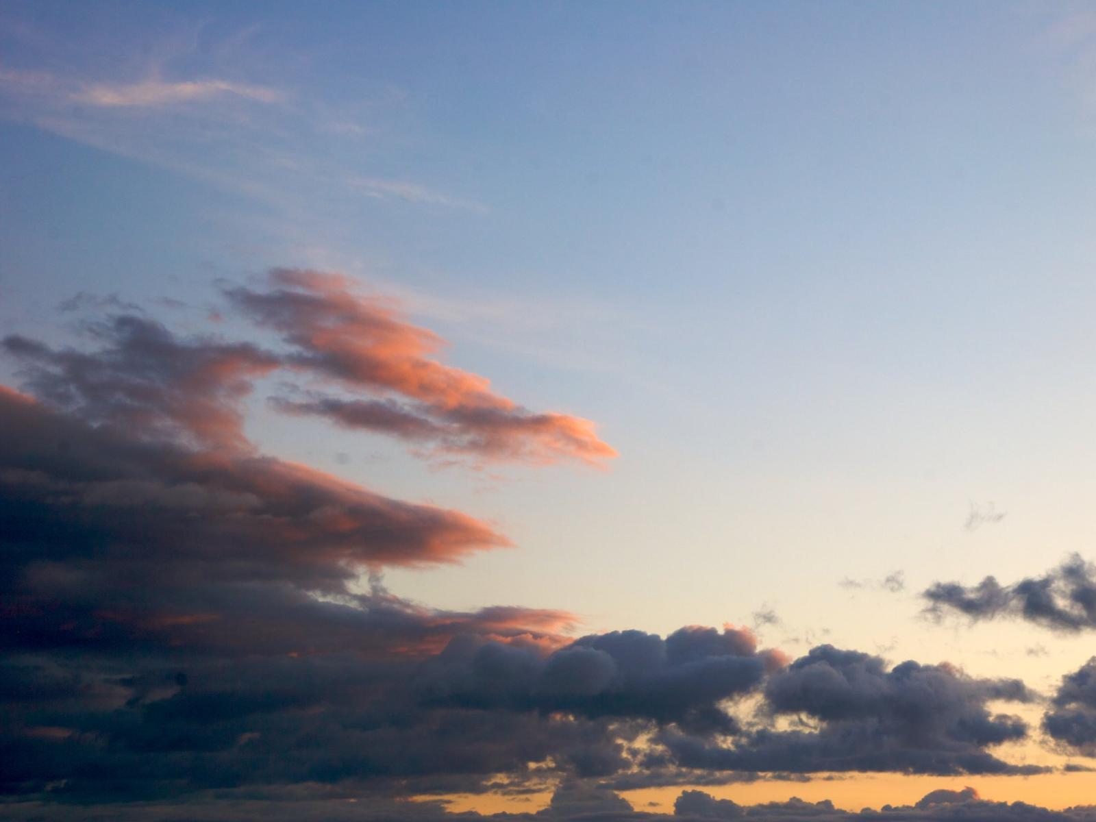 Backlit low clouds on blue sky