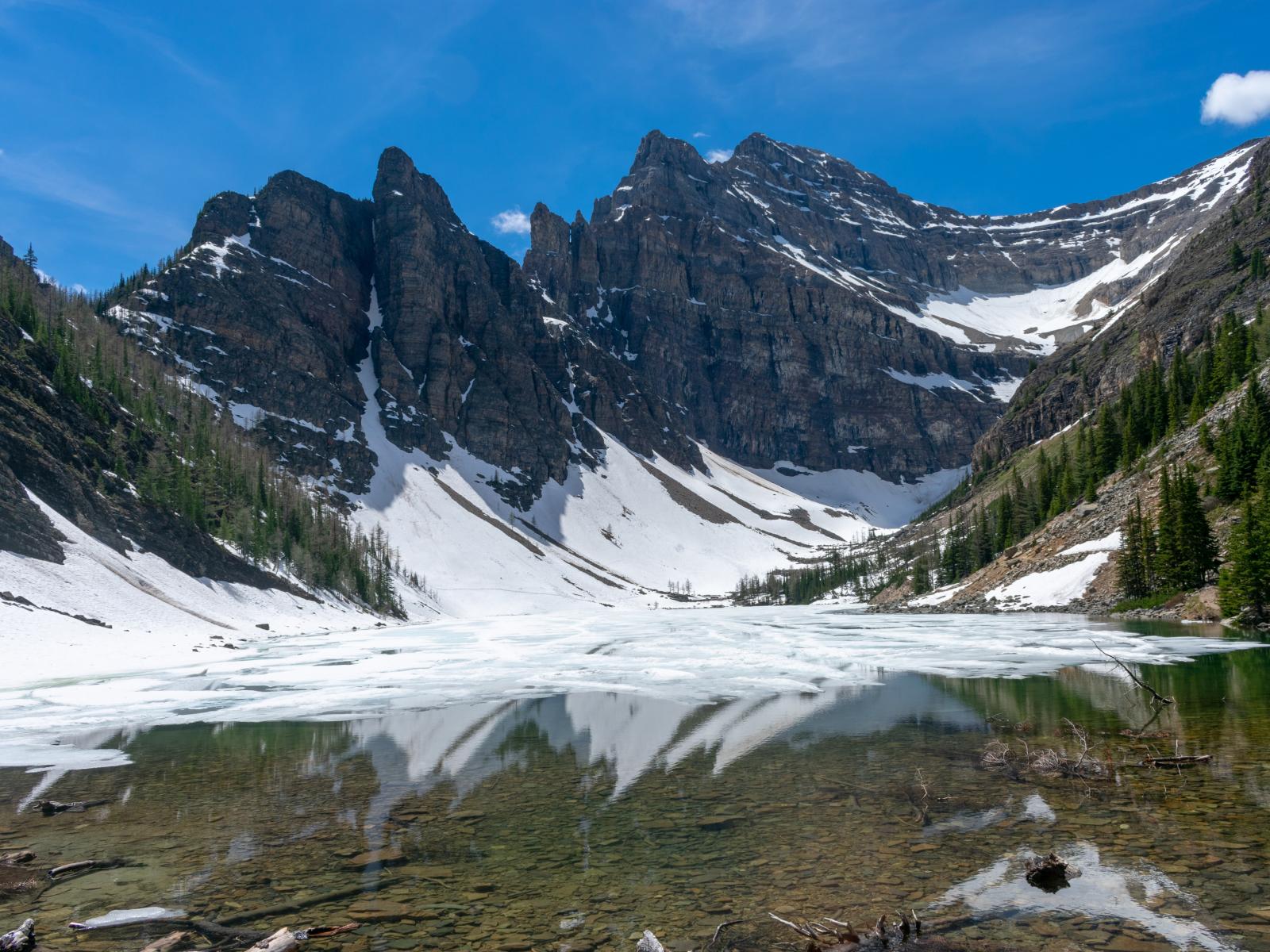 lake surrounded with mountain covered in snow