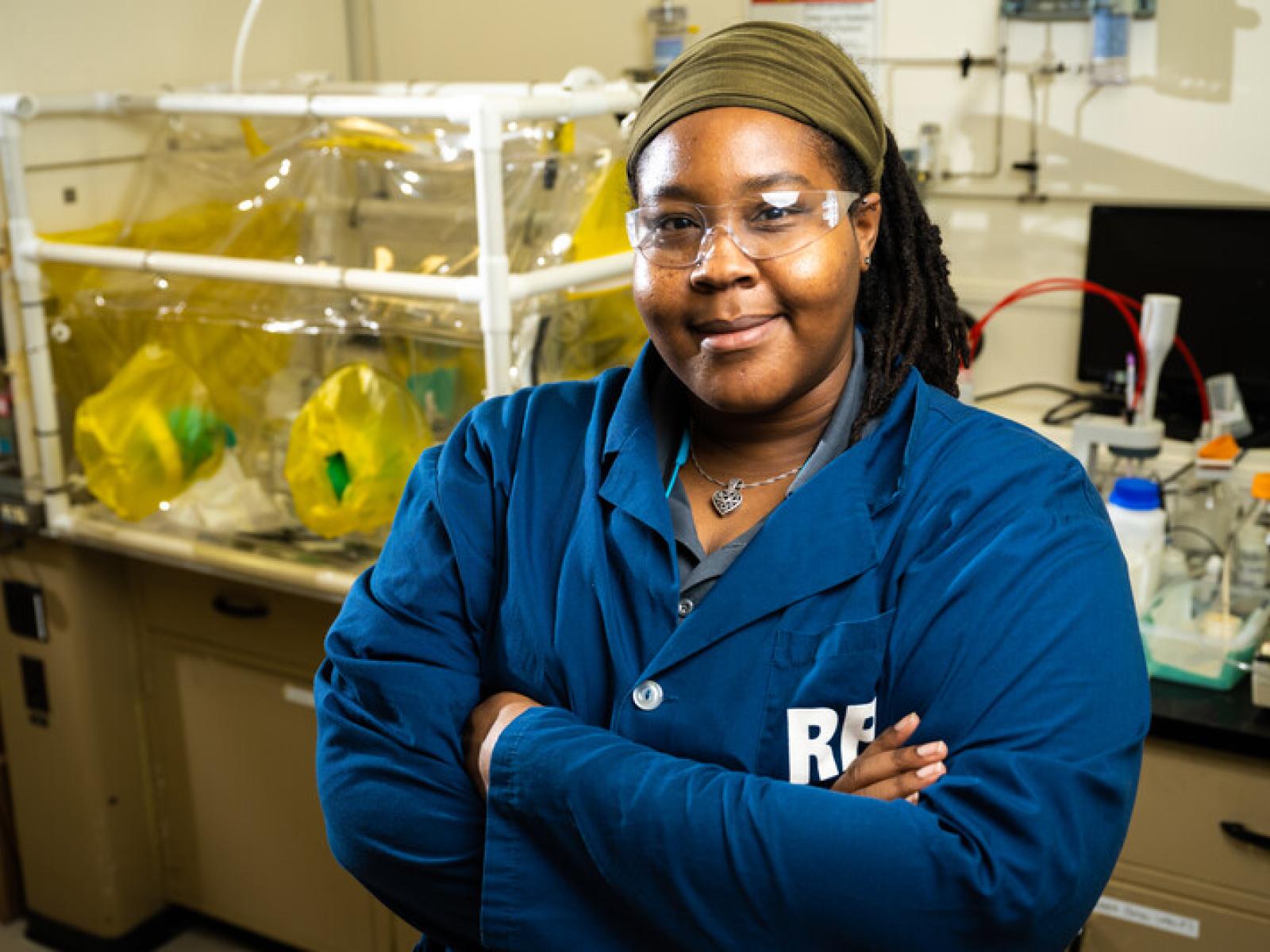 Shirmir Branch stands in front of laboratory equipment