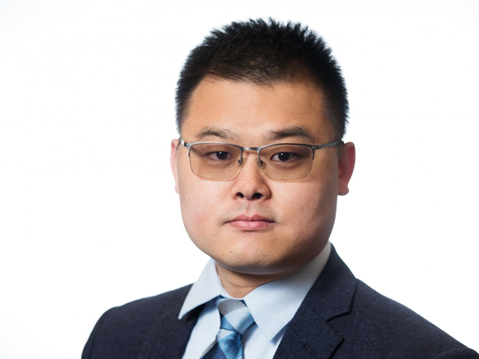 photo of a man wearing glasses in a suit