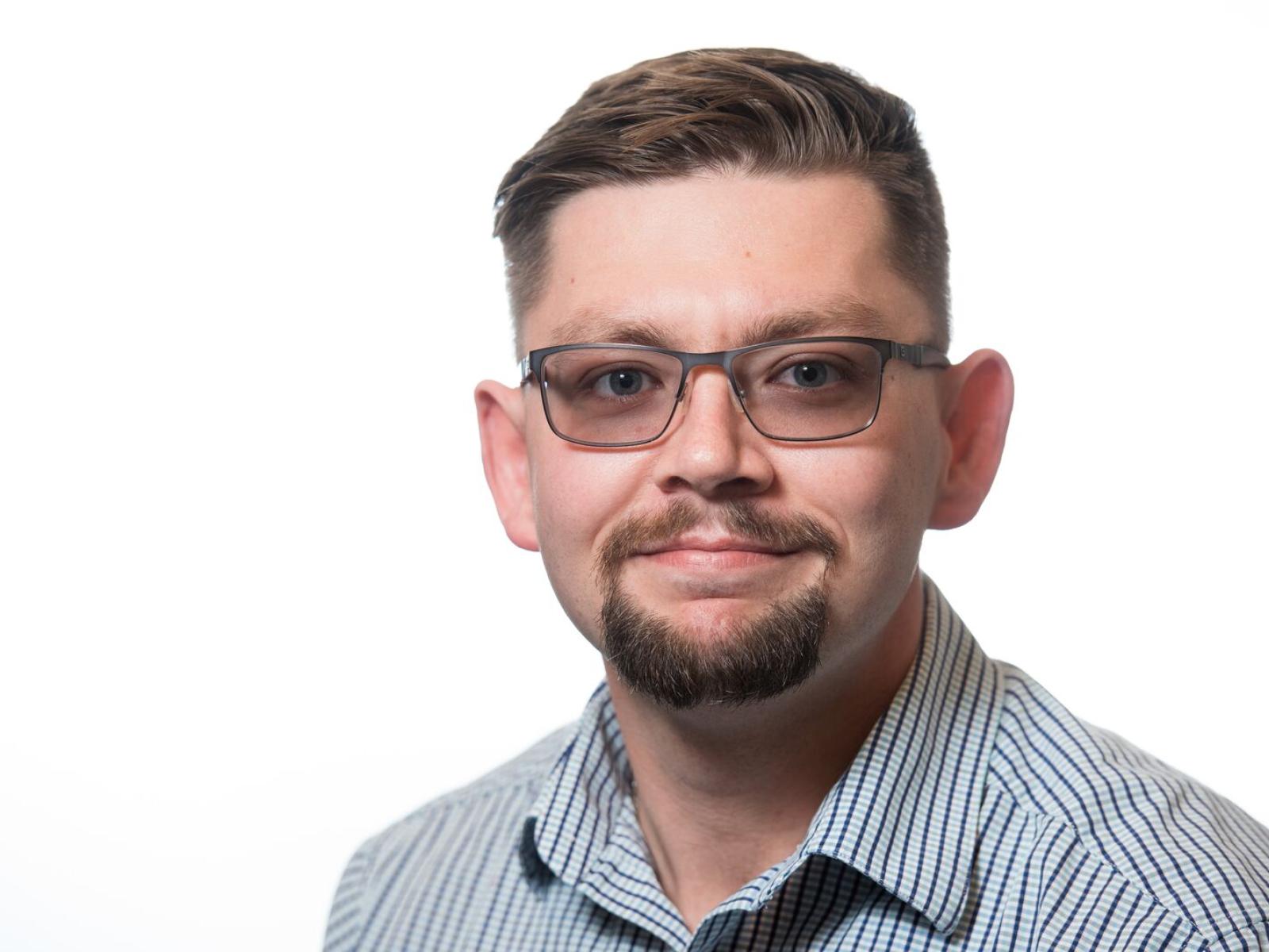 Fayette in blue and white strip shirt with white background. 