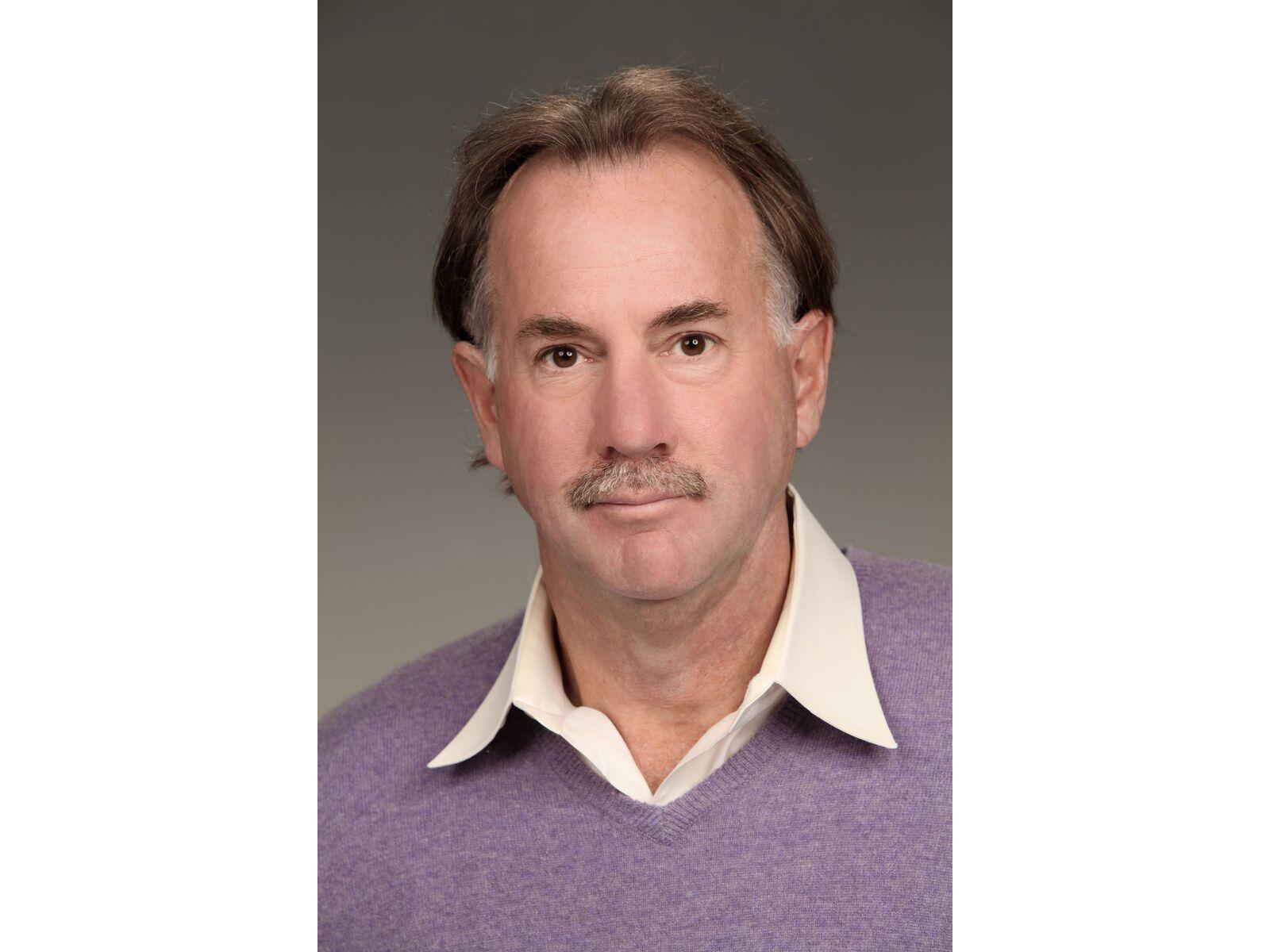 Tim J. Johnson, man wearing a purple sweater