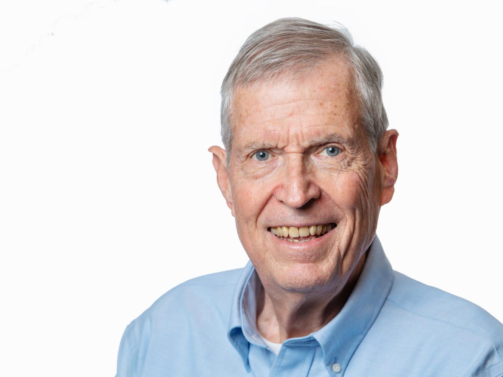 Photograph of a smiling man wearing business attire
