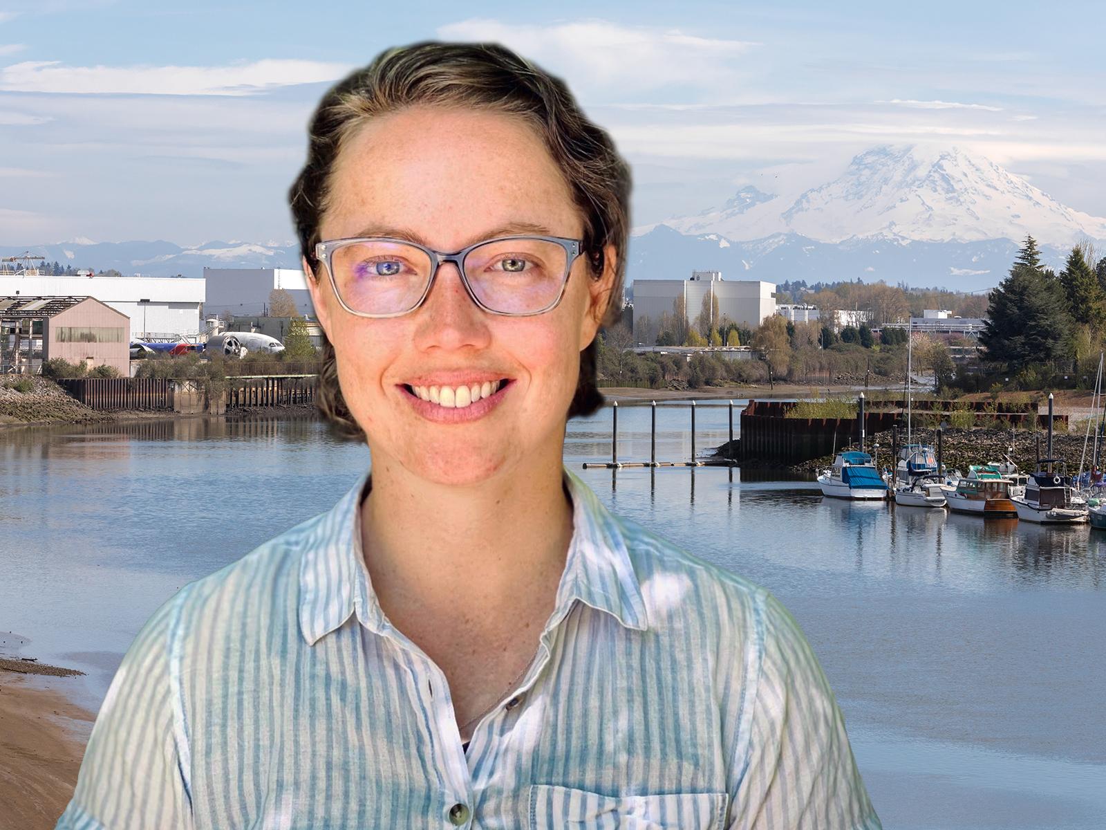 Oceanographer Maggie McKeon with a background of Mt Rainer and the Duwamish River, where she did her research.