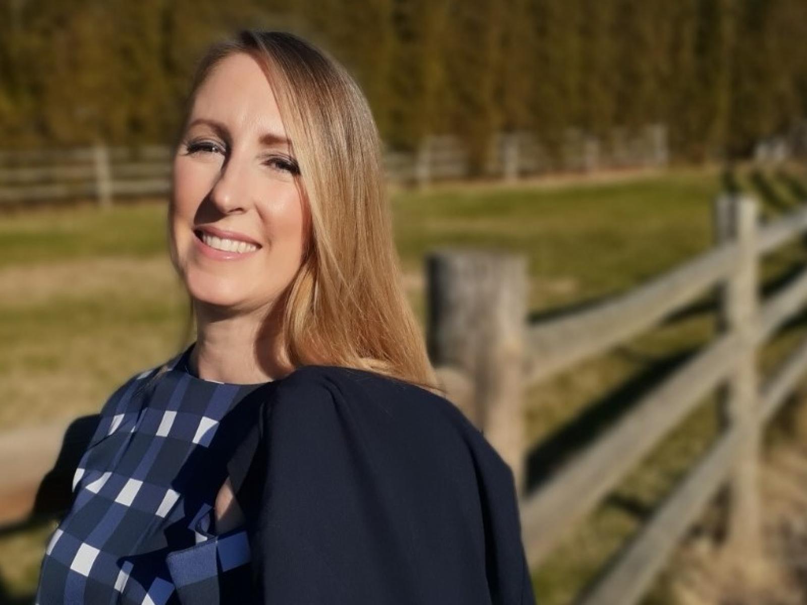 Photo of woman with blue jacket and blonde hair