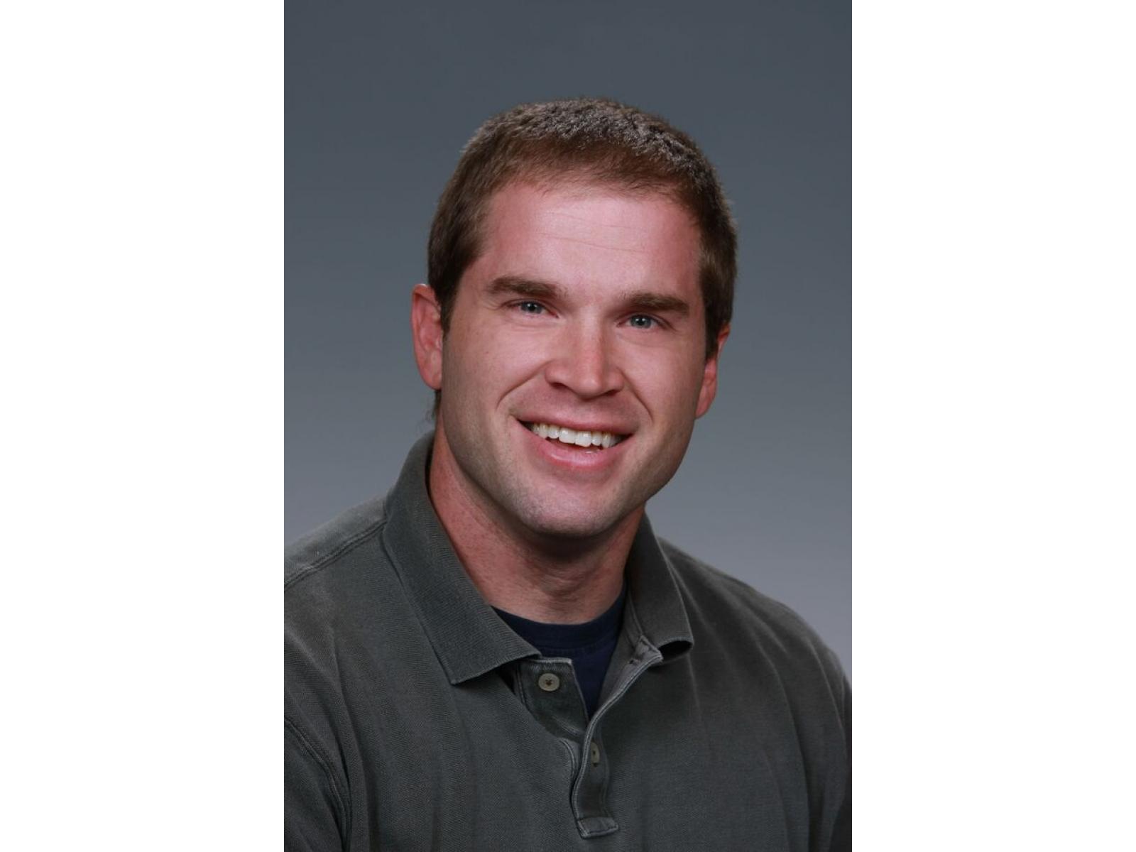 Man smiling in dark shirt