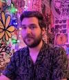 Travis Hager, picutred here with a neon funky background, is an early career research with the CUSSP EERC.