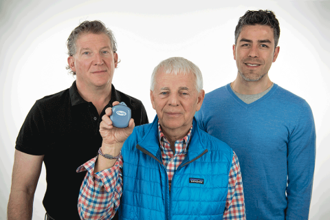 PNNL researchers Michael Hughes (left), James Skorpik (center), and Eric Gonzalez (right) are pictured holding the golf-ball sized sensor that contains a Wi-Fi enabled microcontroller, microphone, and battery. When it detects a gunshot, this information is sent automatically and wirelessly to initiate a lockdown procedure, activate alarms, and trigger an emergency call to law enforcement.