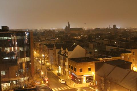 Photograph of a town at night with bright lights