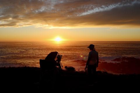 The sun sets beyond the horizon as the team sets up the tethered balloon system for nighttime operations. 