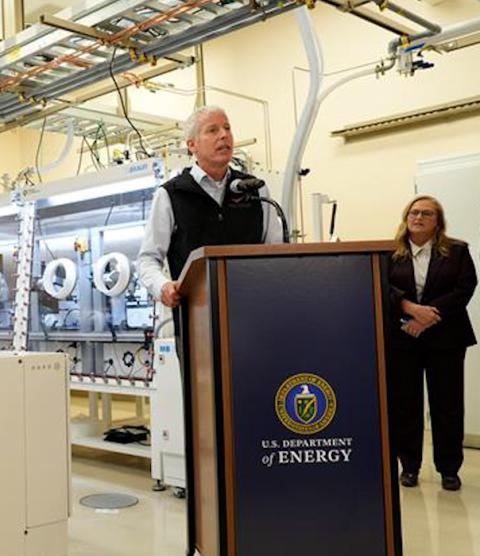 Secretary of Energy Chris Wright speaks at a podium in front of the AMP2 equipment room