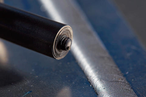 PNNL's patented friction stir scribe tool (foreground) joins two dissimilar materials: aluminum and steel (background).