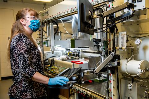 Photo of a PNNL researcher using High Throughput Experimentation equipment.