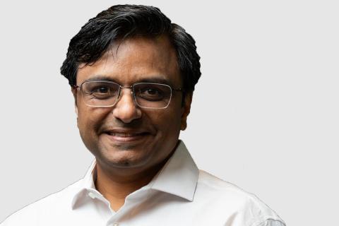 Headshot of Mahantesh Halappanavar with a light gray background