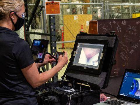 Researcher Kayte Denslow views multiple camera angles during a test to inspect a mock-up of the bottom of an underground tank, like those that store nuclear waste at the Hanford Site. 
