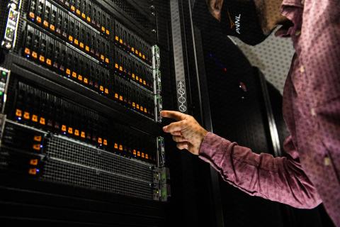 Picture of a man pressing a switch on a electronic tray