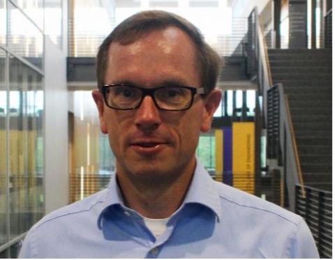 William Moe, an engineering professor, has short brown hair and wears glasses.
