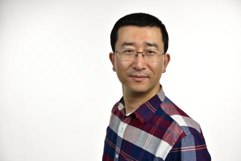 Man in glasses with red, white and blue plaid shirt