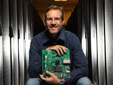 Photo of man holding a computer board