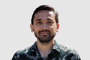 Headshot of Anurag Acharya with a light gray background