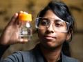 PNNL chemist Jotheeswari Kothandaraman holds EEMPA, a carbon-capturing solvent used in her most recent study.