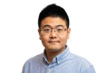 a man with glasses and short black hair
