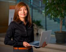 Nora Wang holding laptop