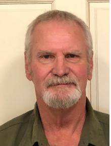 Peter Lee, a geologist and hydrologist, has short white-gray hair and a goatee-mustache.