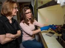 Scientists Sue Clark and Amanda Lines use a laser for nuclear chemistry research.
