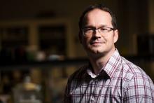 Man in plaid shirt and glasses